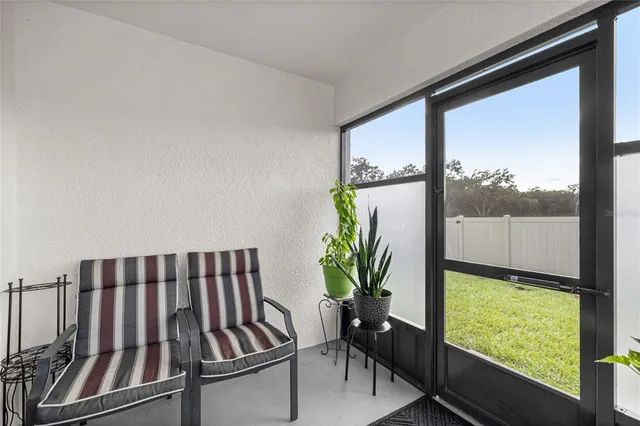 a view of a porch with furniture and a window