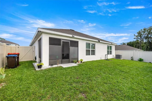 a backyard of a house with table and chairs