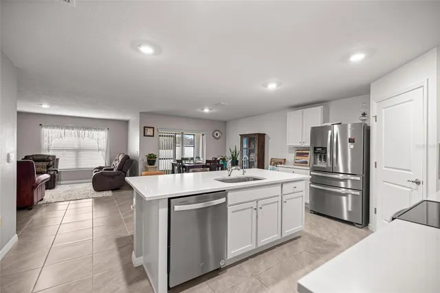 a kitchen with refrigerator and cabinets