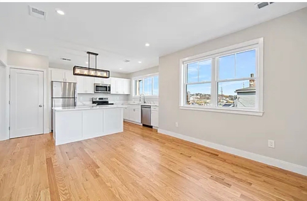 2-4 Hecla Street, Unit 1 Boston, MA 02122 - Photo 1 of 9 a view of kitchen with wooden floor