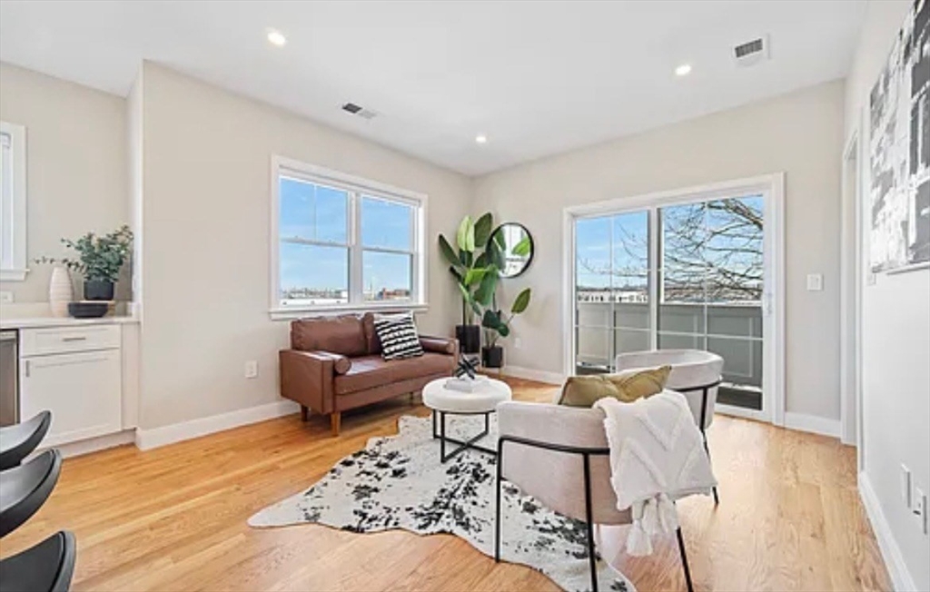 2-4 Hecla Street, Unit 1 Boston, MA 02122 - Photo 5 of 9 a living room with furniture and a large window