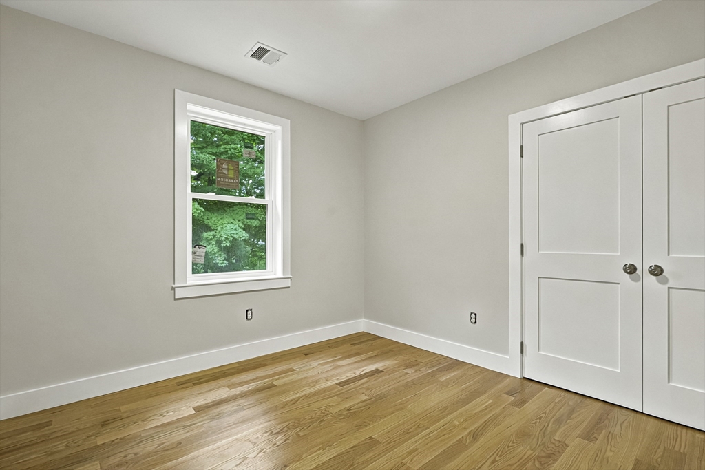 4 Mayhew Street Framingham, MA 01702 - Photo 28 of 42 an empty room with wooden floor closet and windows