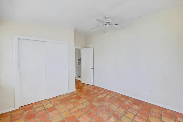 a view of a room with a wooden floor and white walls