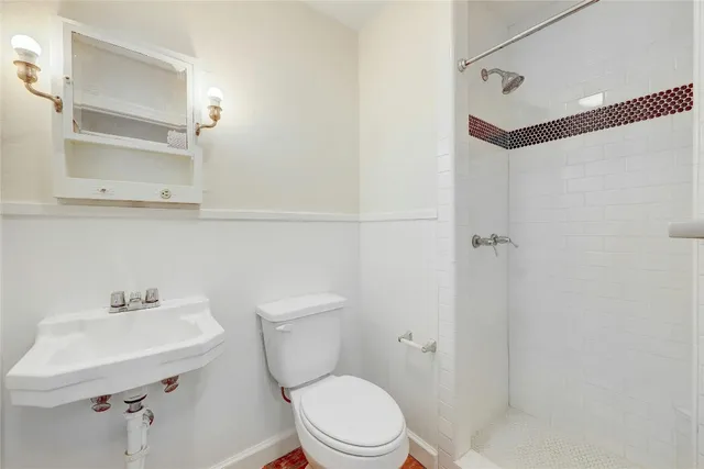 a white toilet sitting next to a bathroom sink