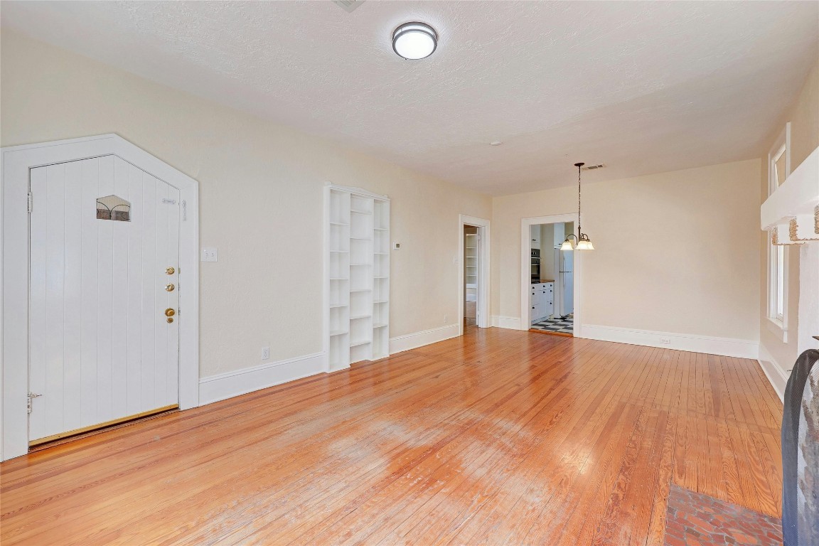 1920 Newning Avenue Austin, TX 78704 - Photo 5 of 26 a view of an empty room with wooden floor and a window