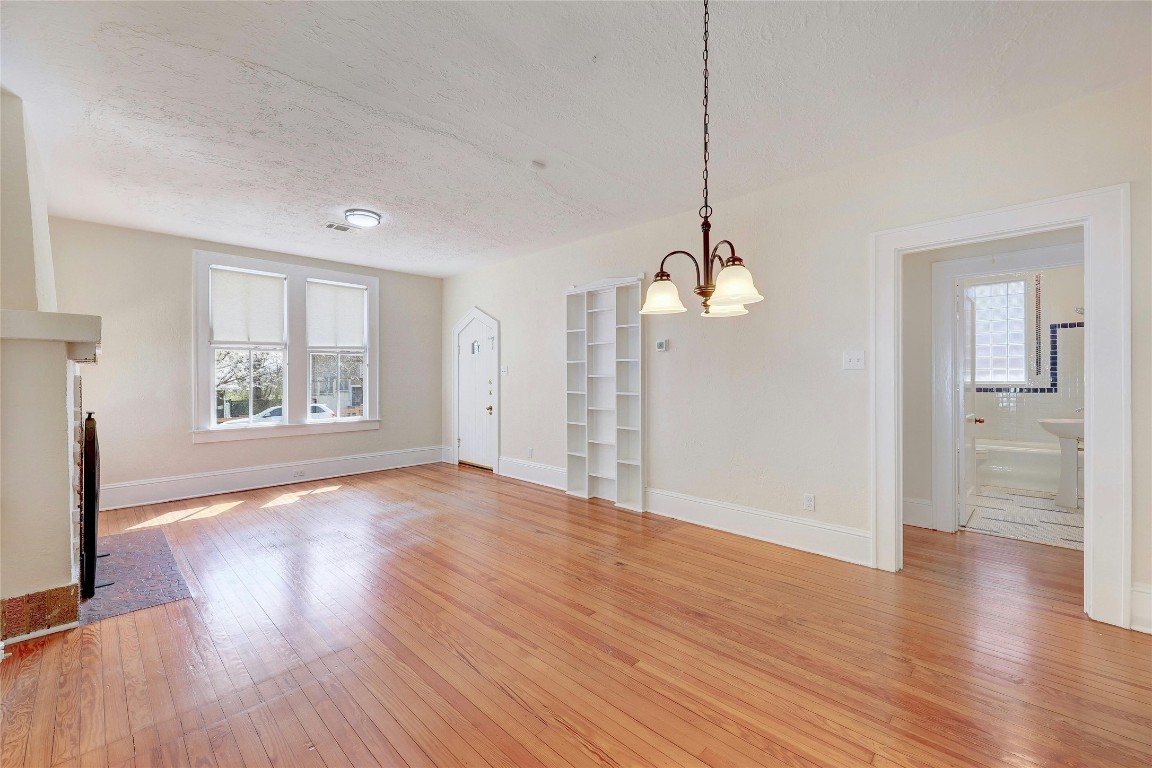 1920 Newning Avenue Austin, TX 78704 - Photo 6 of 26 a view of an empty room with wooden floor and a window