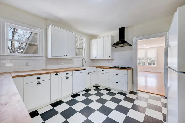 a kitchen with stainless steel appliances a stove a sink and a refrigerator