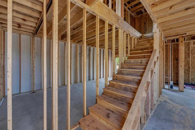 a view of entryway with wooden floor and stairs
