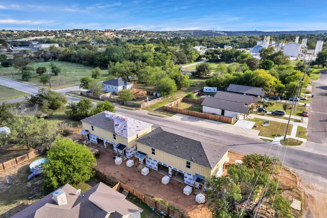 an aerial view of a houses with a yard