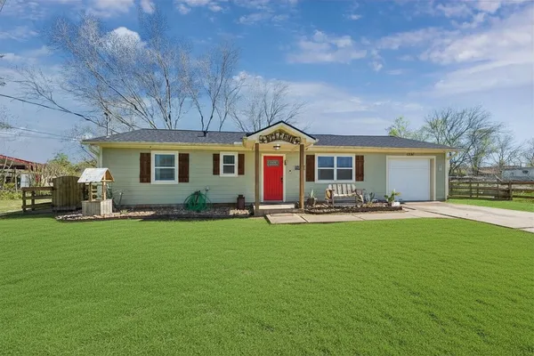 a front view of the house with yard patio and green space
