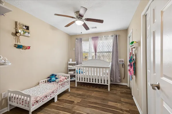 a bedroom with furniture and a flat screen tv