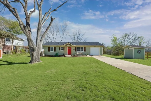 a front view of house with yard and green space