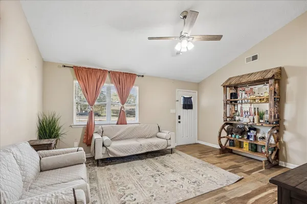 a bedroom with furniture and a large window