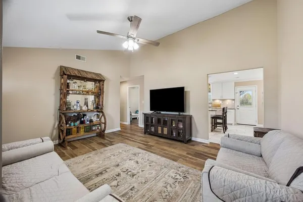 a bedroom with furniture and a flat screen tv