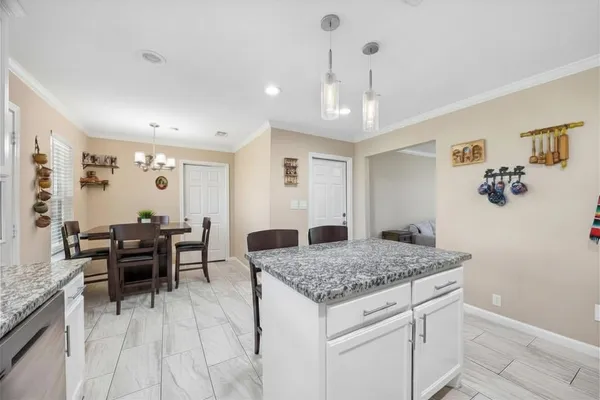 a kitchen with kitchen island granite countertop wooden cabinets and stainless steel appliances