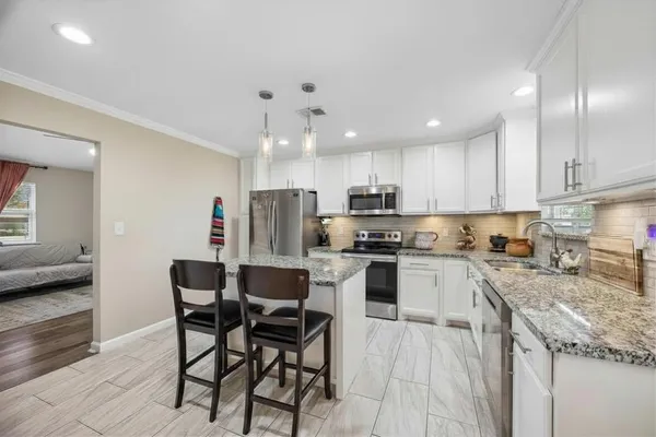 a view of a dining room with furniture and chandelier