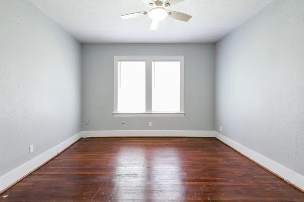 a view of wooden floor and windows in a room