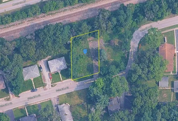 an aerial view of a house with a yard basket ball court and outdoor seating