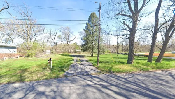 a view of a backyard with tree s