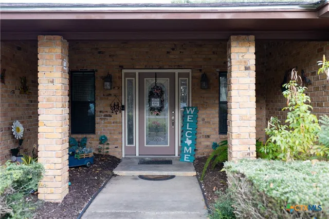a front view of a house with a black gate