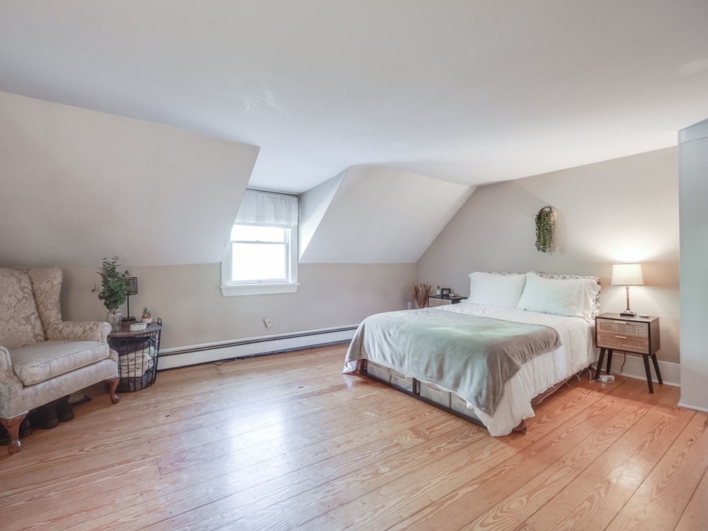 59 Hubbardston Road Templeton, MA 01468 - Photo 18 of 28 a bedroom with a bed a couch and wooden floor