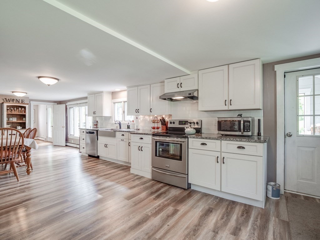 59 Hubbardston Road Templeton, MA 01468 - Photo 2 of 28 a kitchen with a white cabinets and white appliances