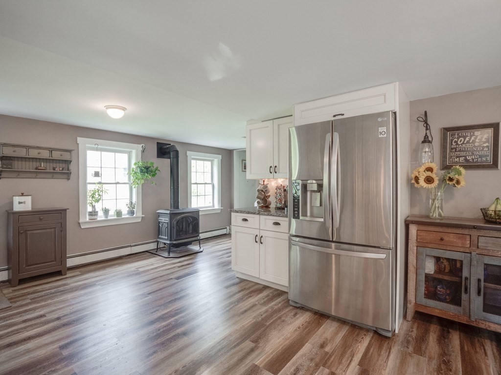 59 Hubbardston Road Templeton, MA 01468 - Photo 6 of 28 a kitchen with a refrigerator a stove a sink and dishwasher with wooden floor