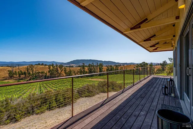 a dining area with stainless steel appliances kitchen island granite countertop a wooden table and chairs