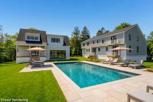 a view of a house with swimming pool and sitting area