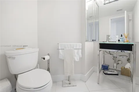 a white toilet sitting next to a bathroom sink