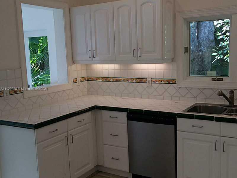 3797 El Prado Boulevard Miami, FL 33133 - Photo 13 of 26 a kitchen with a sink and cabinets