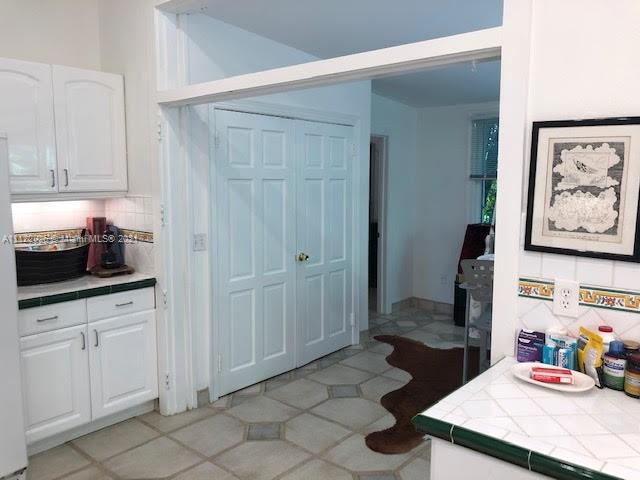 3797 El Prado Boulevard Miami, FL 33133 - Photo 14 of 26 a kitchen with a sink and cabinets