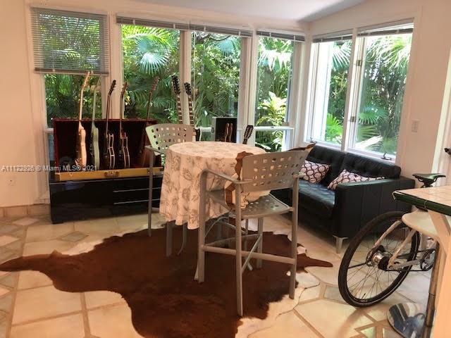 3797 El Prado Boulevard Miami, FL 33133 - Photo 15 of 26 a living room with furniture and a floor to ceiling window