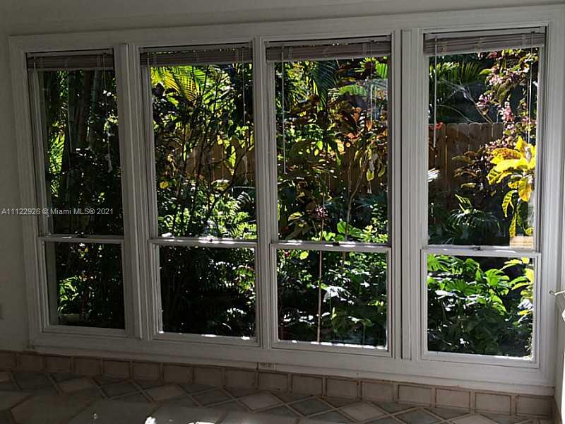 3797 El Prado Boulevard Miami, FL 33133 - Photo 16 of 26 front view of a house with a large window and door