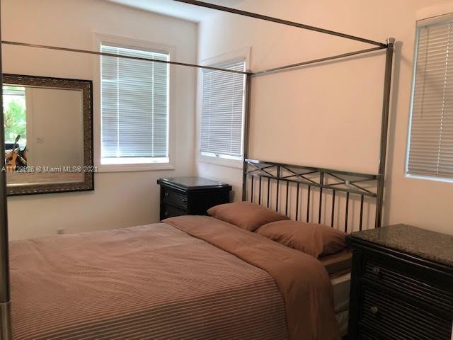 3797 El Prado Boulevard Miami, FL 33133 - Photo 17 of 26 a bedroom with a bed and a window
