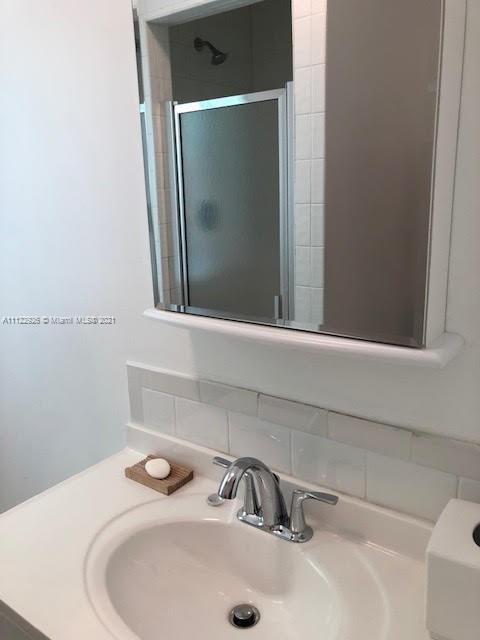3797 El Prado Boulevard Miami, FL 33133 - Photo 19 of 26 a bathroom with a sink and a mirror