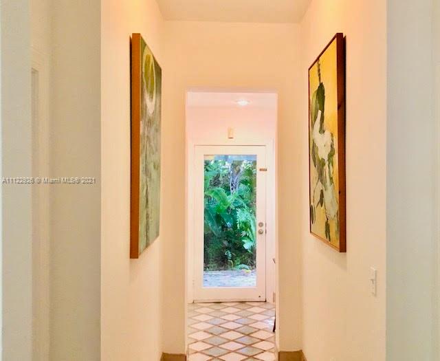 3797 El Prado Boulevard Miami, FL 33133 - Photo 3 of 26 a view of a bathroom from a hallway