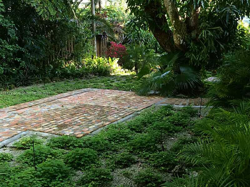 3797 El Prado Boulevard Miami, FL 33133 - Photo 22 of 26 a view of a yard with plants and large trees