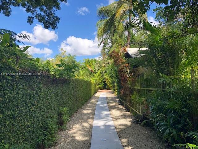 3797 El Prado Boulevard Miami, FL 33133 - Photo 25 of 26 a view of a pathway both side of building