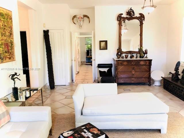 3797 El Prado Boulevard Miami, FL 33133 - Photo 5 of 26 a living room with furniture a flat screen tv and a fireplace