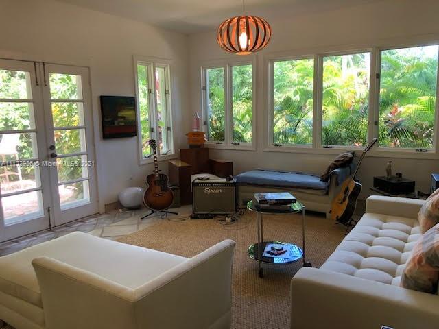 3797 El Prado Boulevard Miami, FL 33133 - Photo 6 of 26 a living room with furniture and a flat screen tv