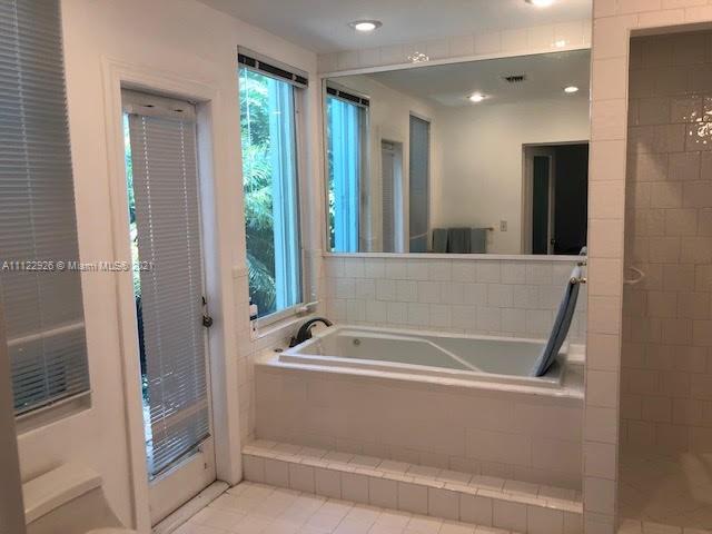 3797 El Prado Boulevard Miami, FL 33133 - Photo 8 of 26 a bathroom with bathtub and shower