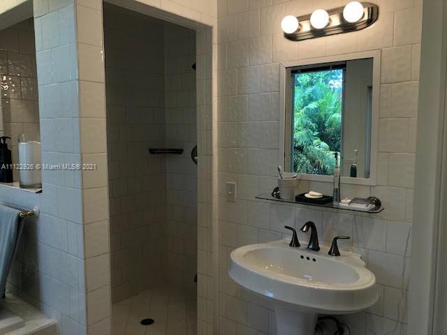 3797 El Prado Boulevard Miami, FL 33133 - Photo 10 of 26 a bathroom with a sink and a mirror