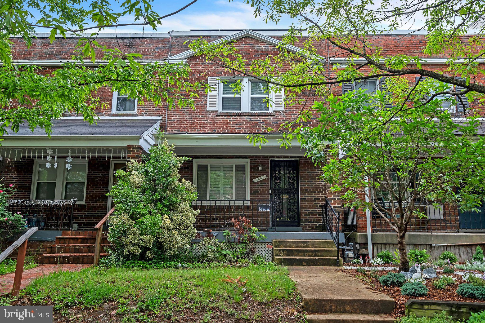 1407 K Street Southeast Washington, DC 20003 - Photo 1 of 30 a front view of a house with a garden