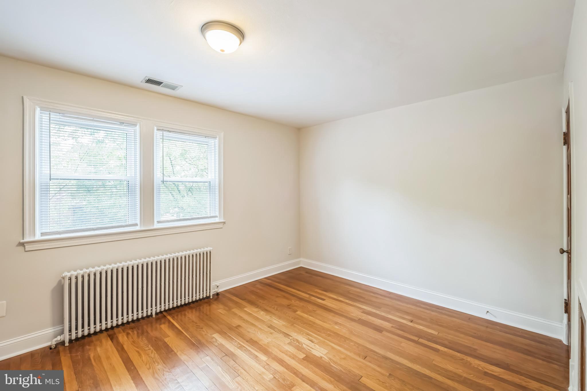 1407 K Street Southeast Washington, DC 20003 - Photo 12 of 30 an empty room with wooden floor and windows