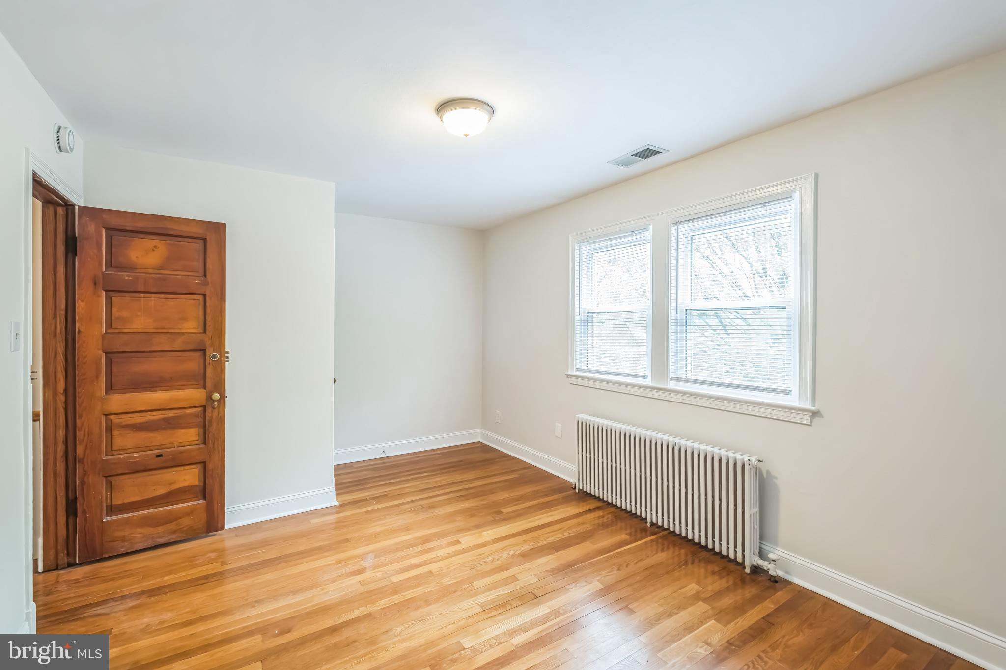 1407 K Street Southeast Washington, DC 20003 - Photo 13 of 30 wooden floor in an empty room with a window