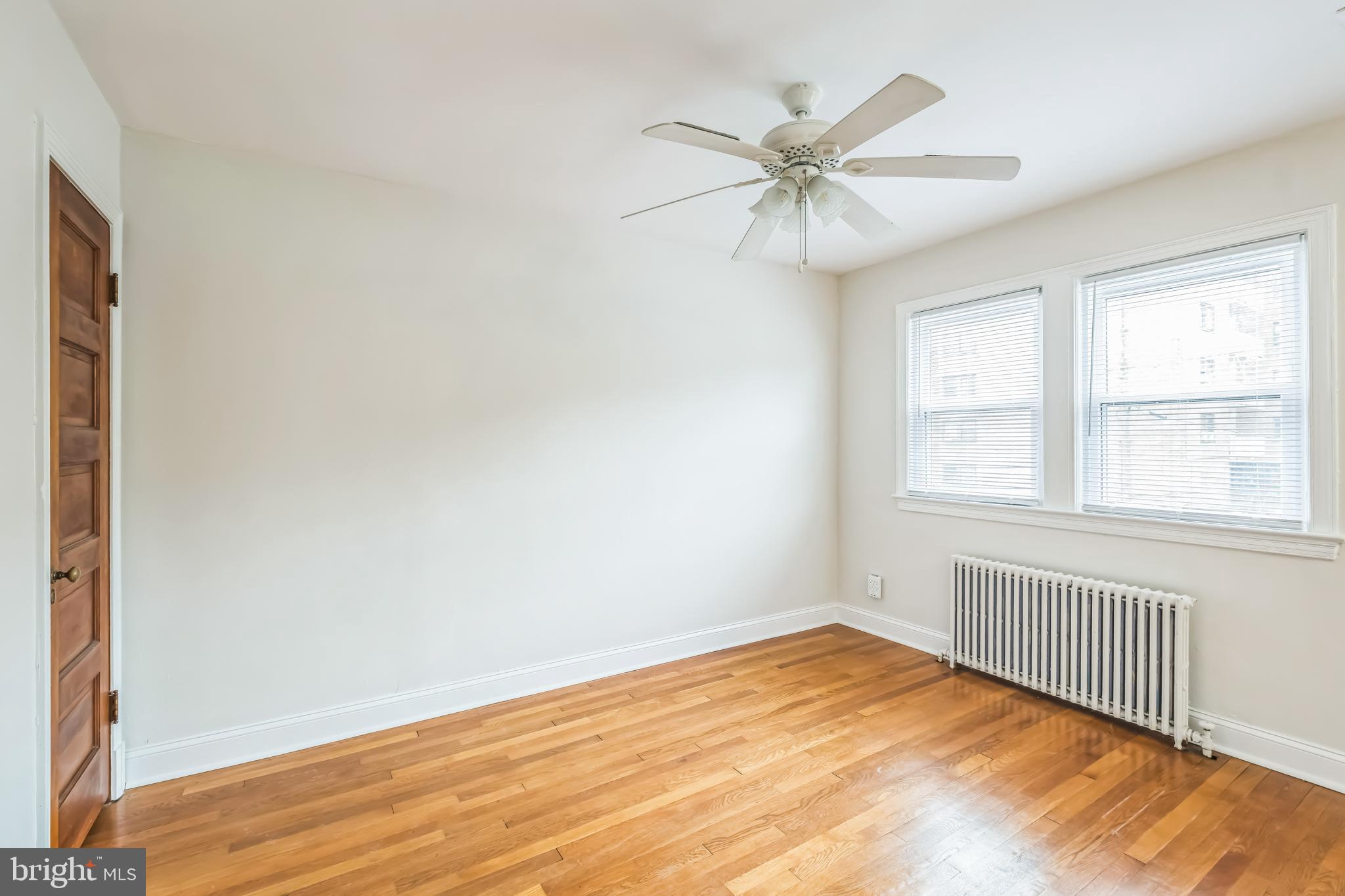 1407 K Street Southeast Washington, DC 20003 - Photo 15 of 30 a view of an empty room with wooden floor and a window