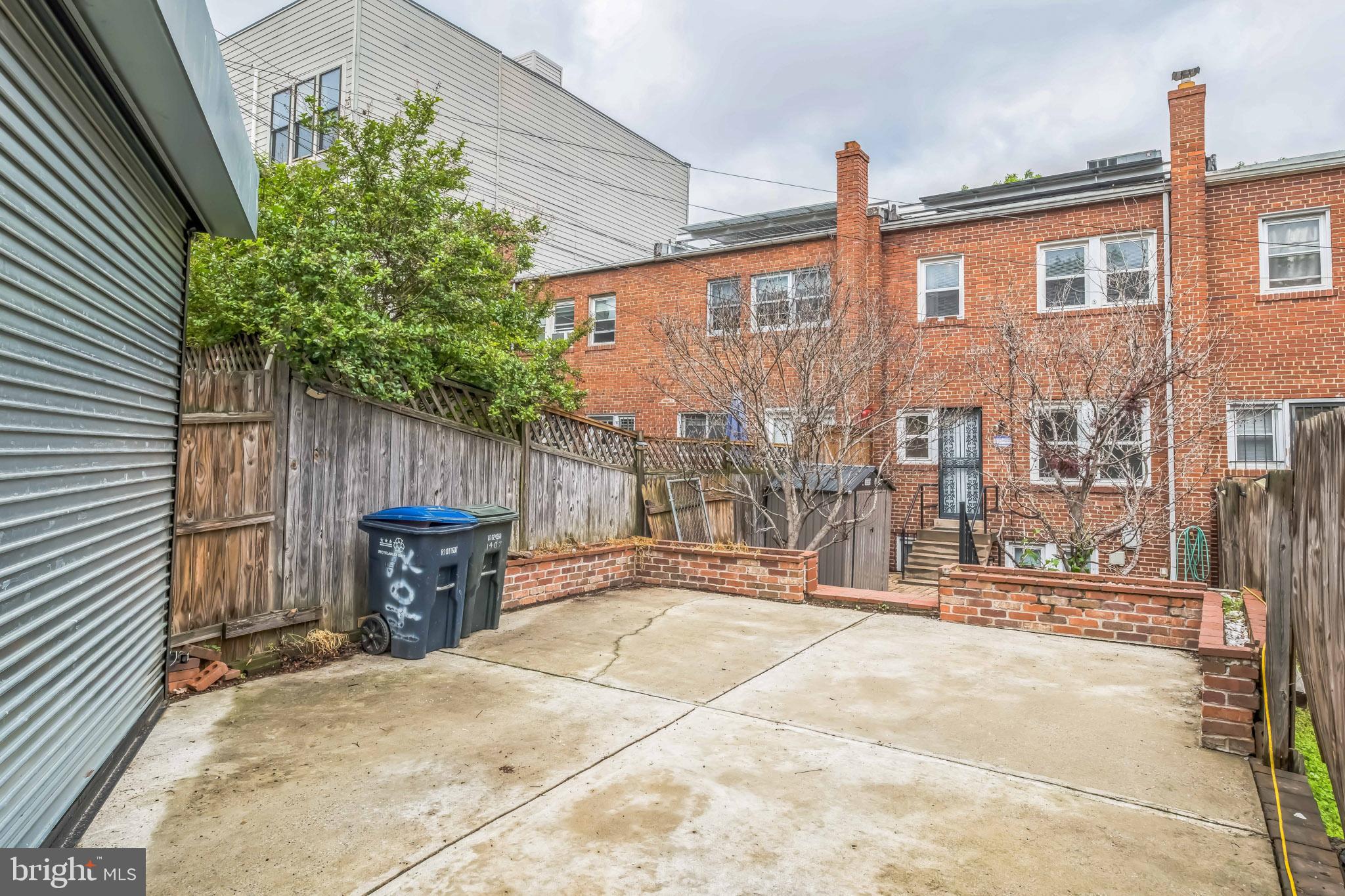 1407 K Street Southeast Washington, DC 20003 - Photo 27 of 30 a backyard of a house with table and chairs