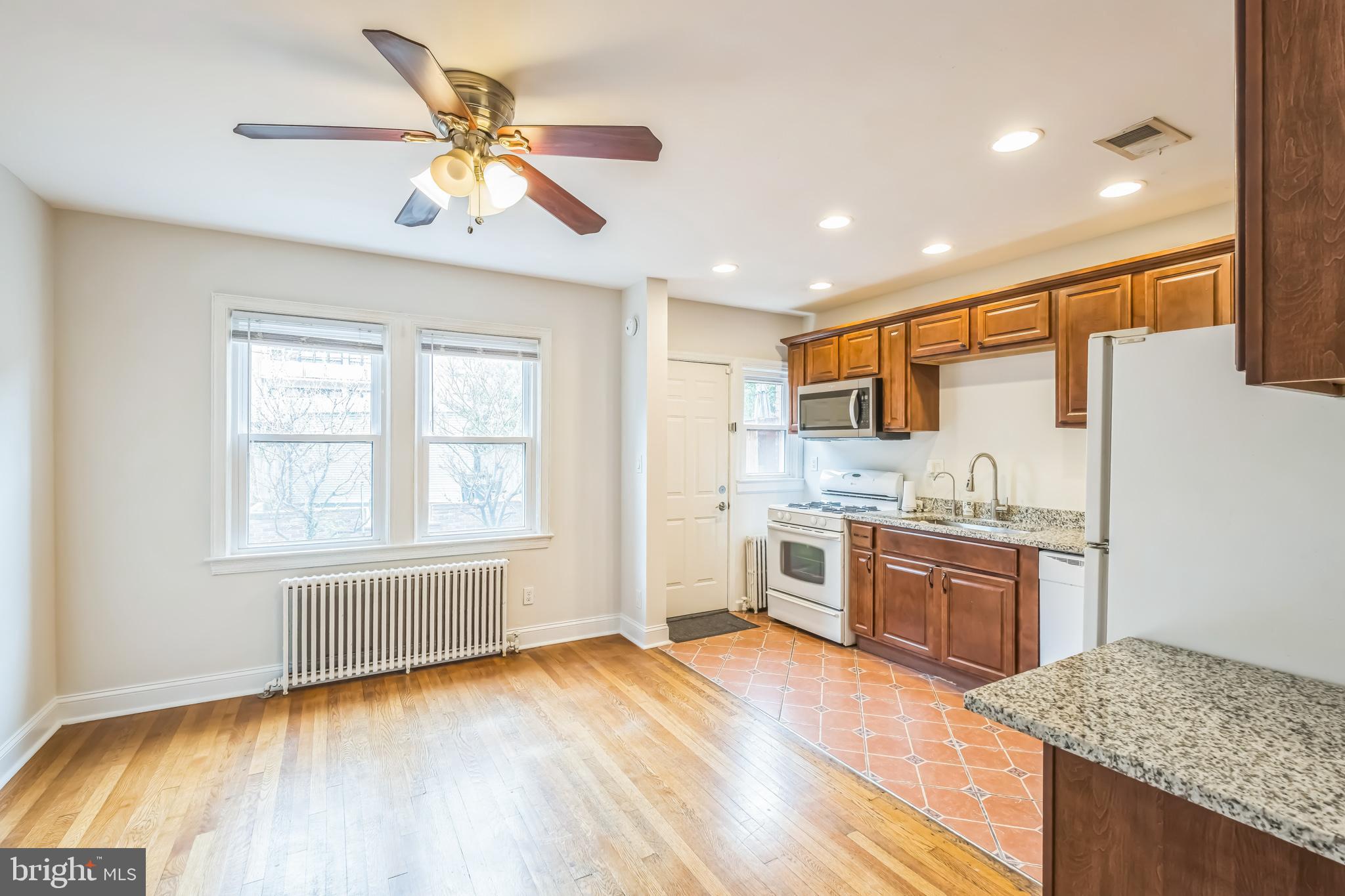1407 K Street Southeast Washington, DC 20003 - Photo 8 of 30 a kitchen with stainless steel appliances granite countertop a stove and a wooden floors