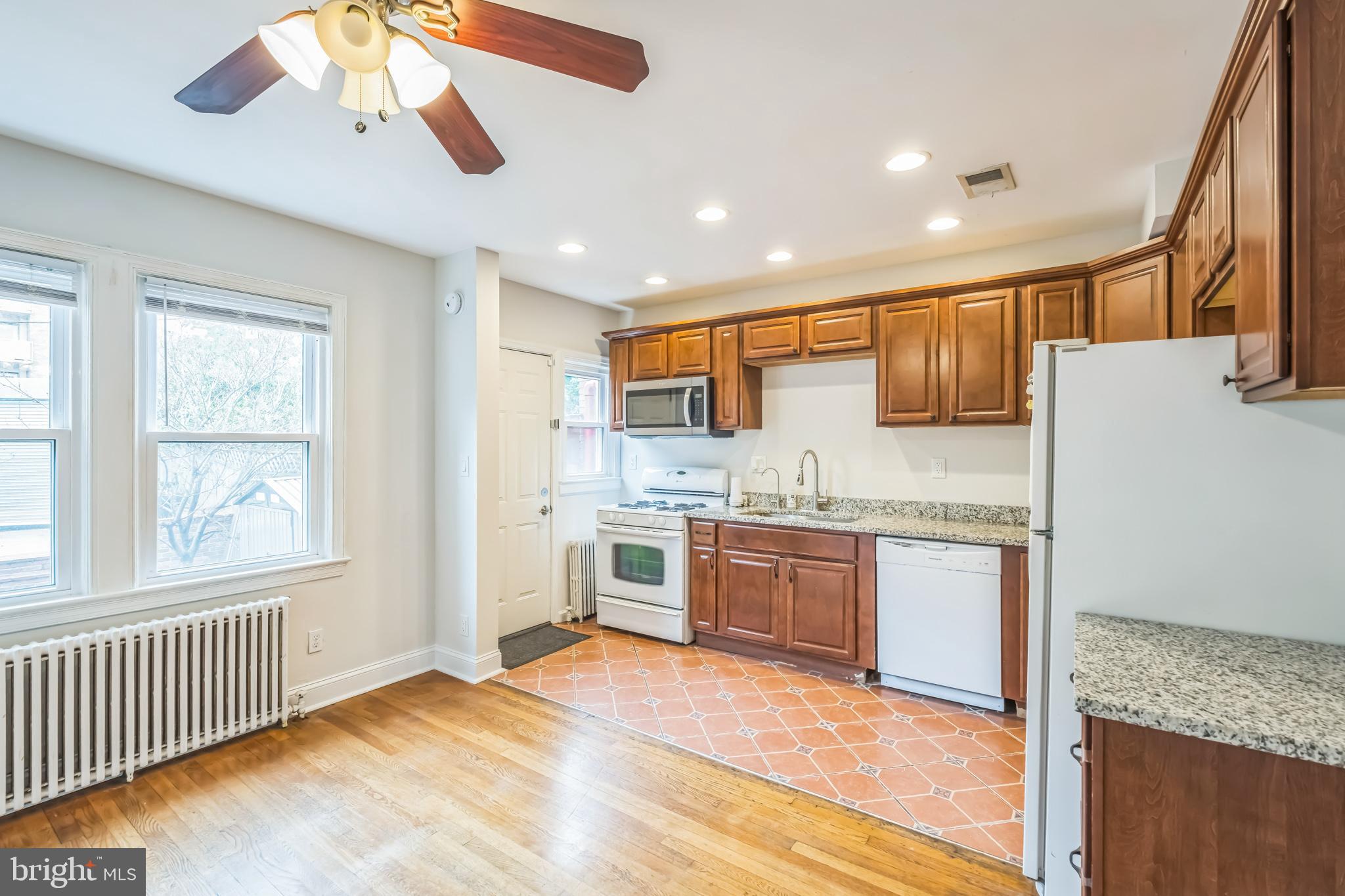 1407 K Street Southeast Washington, DC 20003 - Photo 9 of 30 a large kitchen with a refrigerator a stove top oven a sink and dishwasher with wooden floor